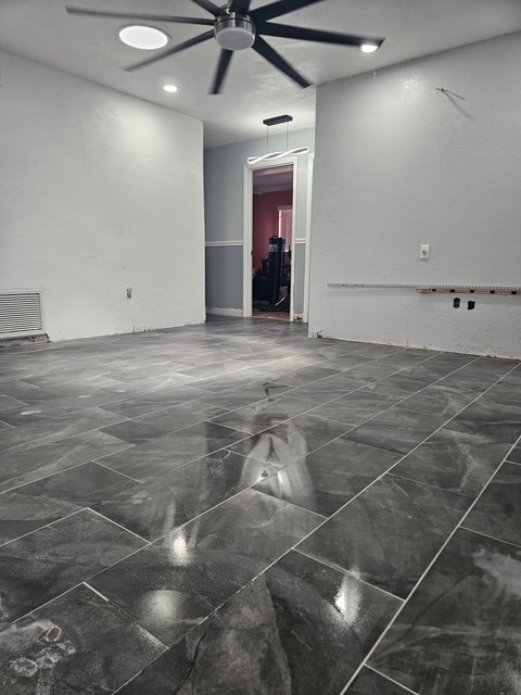 Large-format dark porcelain tile floor installation.